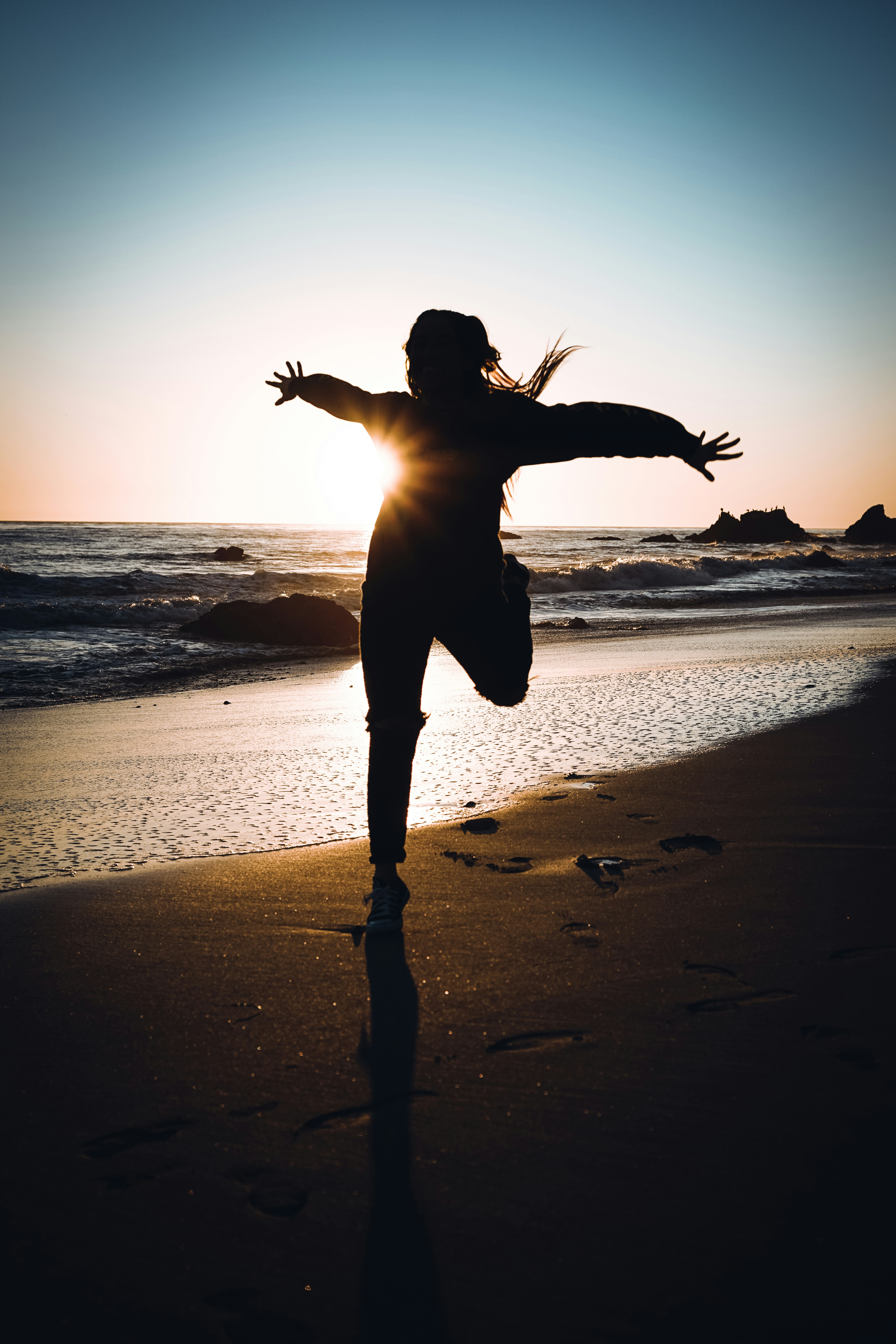 Person enjoying freedom at the beach